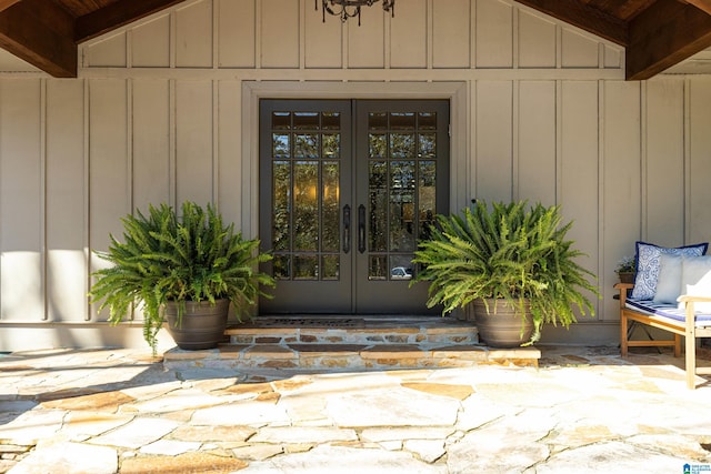 view of exterior entry with french doors and board and batten siding