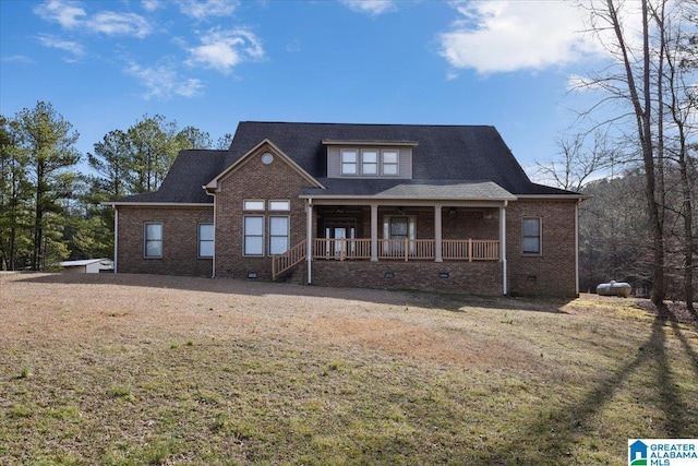 view of front of home featuring a front lawn, brick siding, covered porch, and crawl space