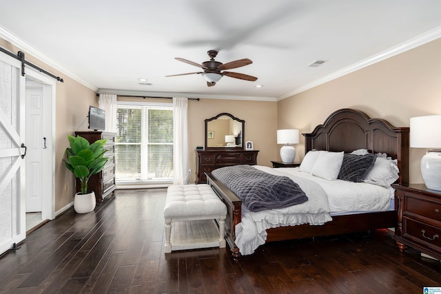 bedroom featuring a barn door, visible vents, wood finished floors, and crown molding