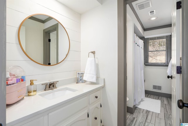 full bathroom featuring vanity, a shower with shower curtain, and visible vents