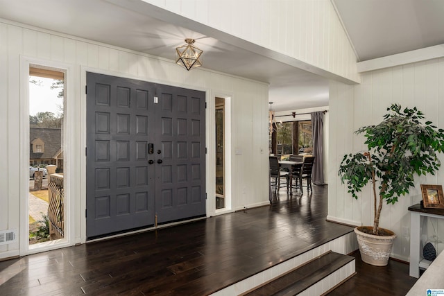 entrance foyer featuring a wealth of natural light, lofted ceiling, and wood finished floors