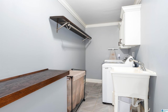 laundry area with cabinet space, baseboards, ornamental molding, and separate washer and dryer