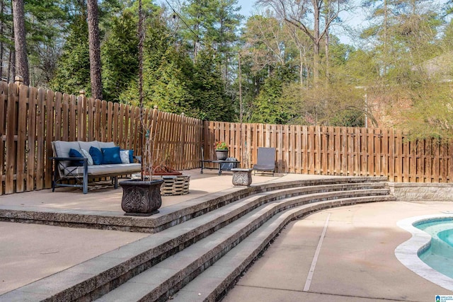 view of swimming pool with a fenced in pool, a patio, an outdoor living space with a fire pit, and a fenced backyard