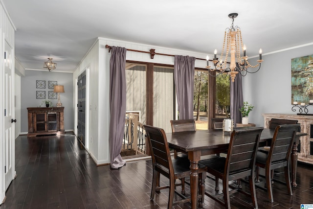 dining room with an inviting chandelier, hardwood / wood-style flooring, baseboards, and ornamental molding