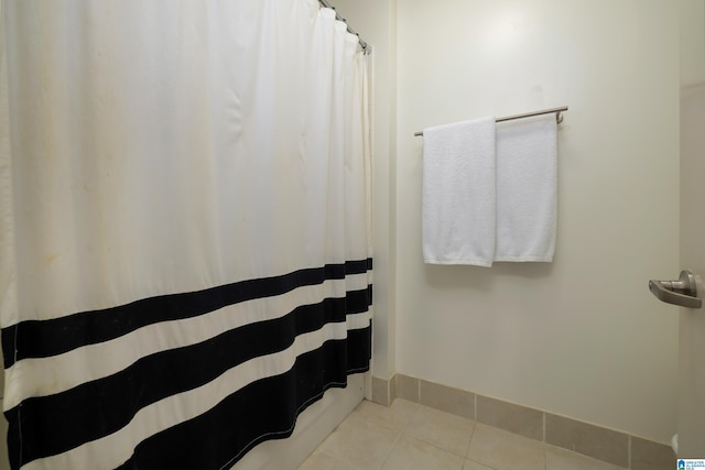 bathroom featuring tile patterned flooring, baseboards, and a shower with curtain