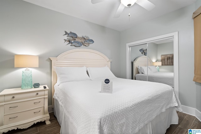 bedroom with a ceiling fan, dark wood-style floors, baseboards, and a closet