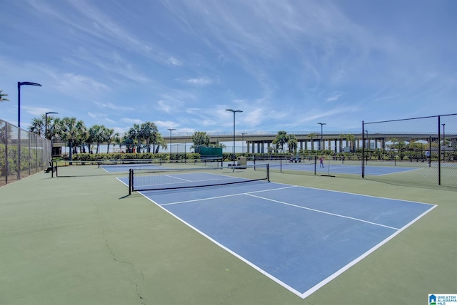 view of tennis court featuring fence