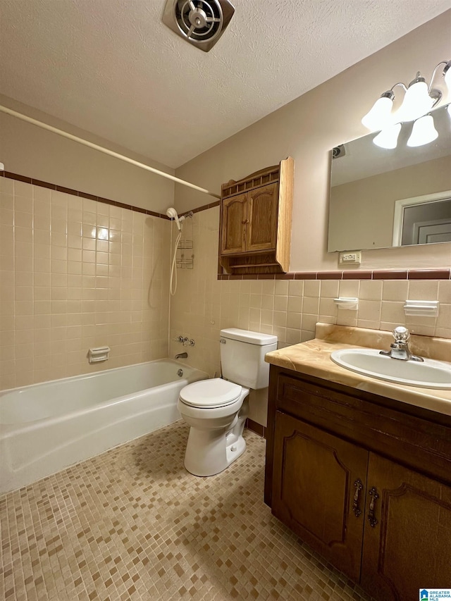 full bathroom with visible vents,  shower combination, a textured ceiling, tile walls, and toilet