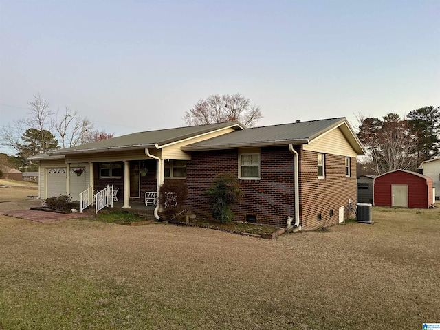 ranch-style home with central air condition unit, a garage, a porch, crawl space, and brick siding