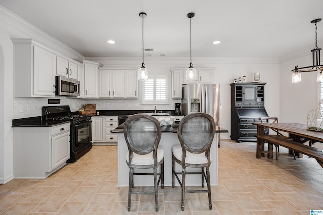 kitchen with backsplash, black appliances, and white cabinets