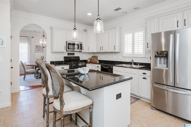 kitchen featuring a wealth of natural light, visible vents, black appliances, a sink, and arched walkways