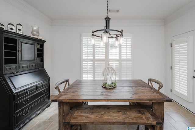 dining area with visible vents, an inviting chandelier, and ornamental molding