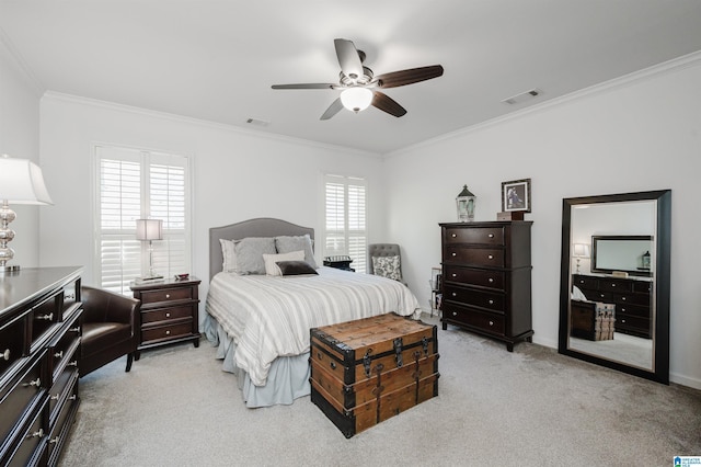 bedroom with visible vents, light carpet, ceiling fan, and crown molding