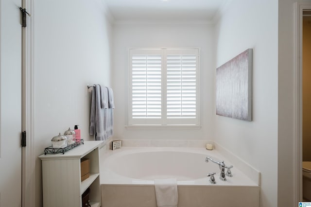 bathroom featuring toilet, crown molding, and a bath