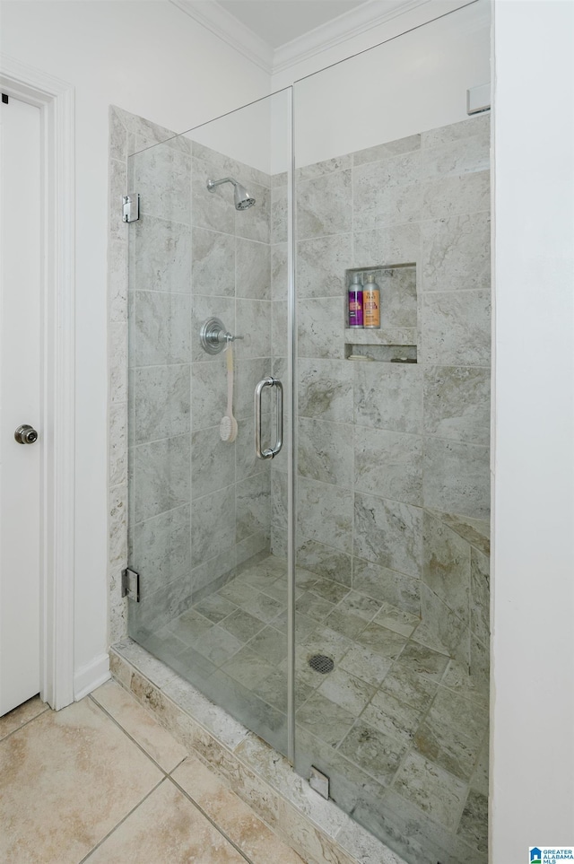 bathroom with a stall shower, crown molding, and tile patterned flooring