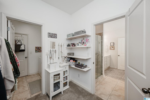 spacious closet featuring light tile patterned flooring