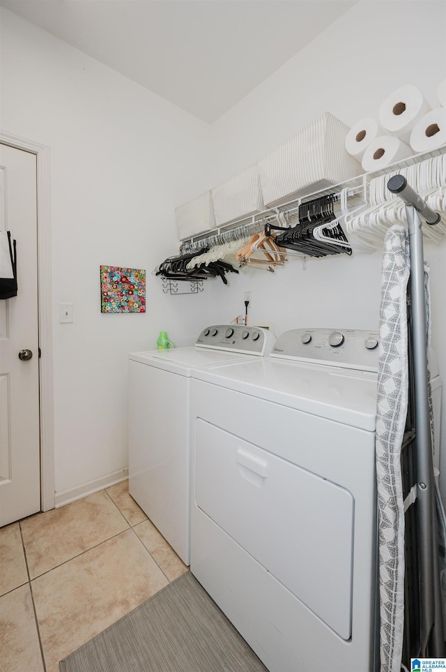 washroom featuring light tile patterned flooring, laundry area, and washing machine and clothes dryer