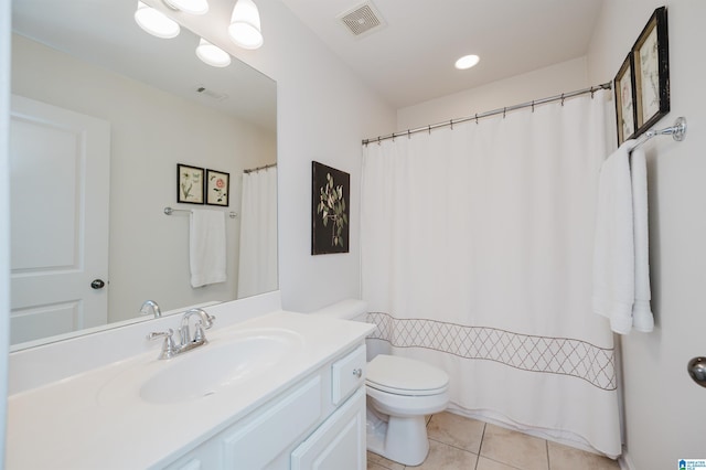 bathroom featuring tile patterned flooring, visible vents, toilet, and vanity