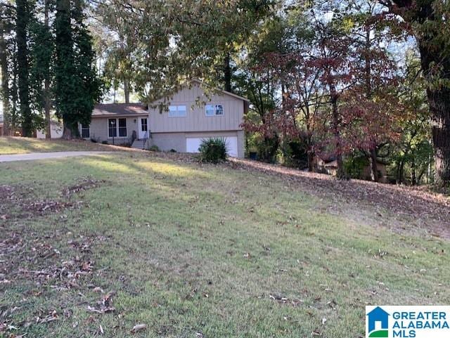 view of front of home with a front yard and a garage