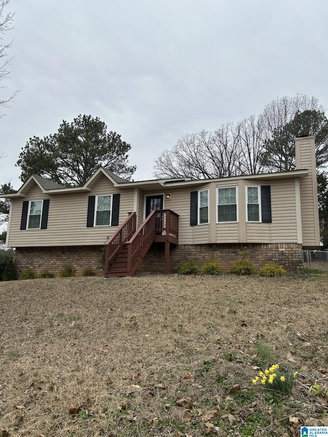 manufactured / mobile home featuring stairs and a chimney