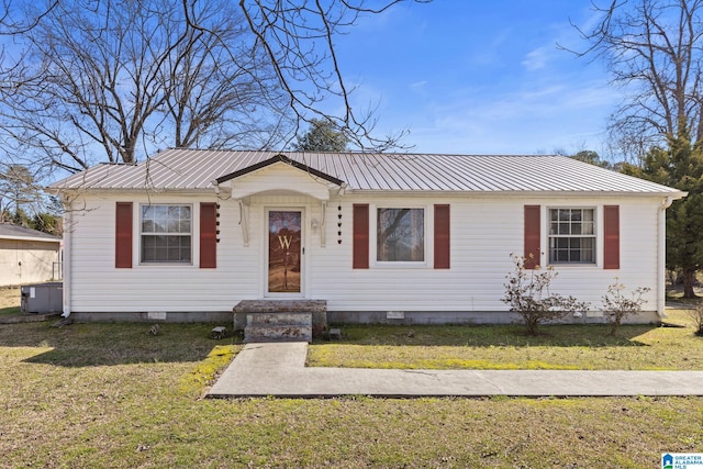 view of front facade with crawl space, metal roof, central AC, and a front yard