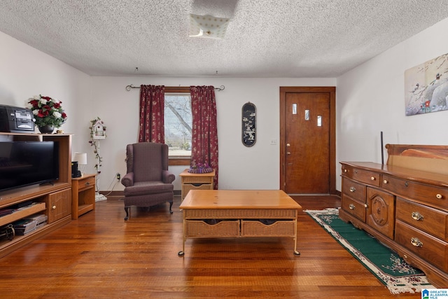 living room with wood finished floors and a textured ceiling