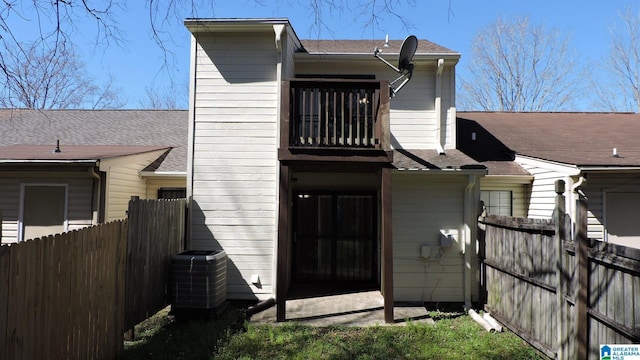 back of property with cooling unit and fence