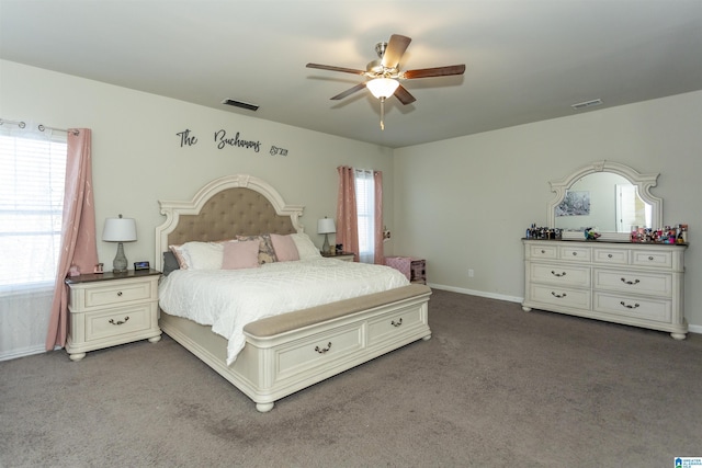 bedroom with visible vents, carpet flooring, baseboards, and ceiling fan