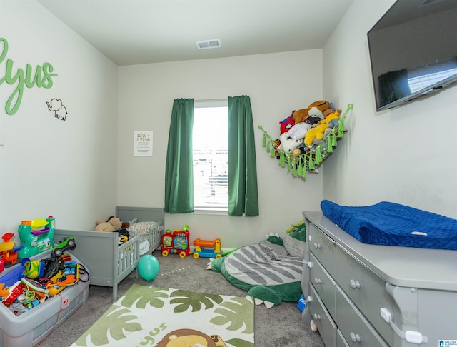 carpeted bedroom featuring visible vents