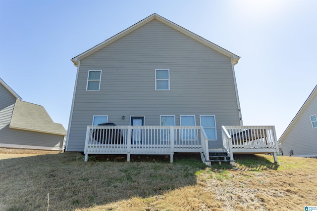 back of property featuring a yard and a deck