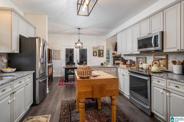 kitchen featuring backsplash, dark wood-style floors, and appliances with stainless steel finishes