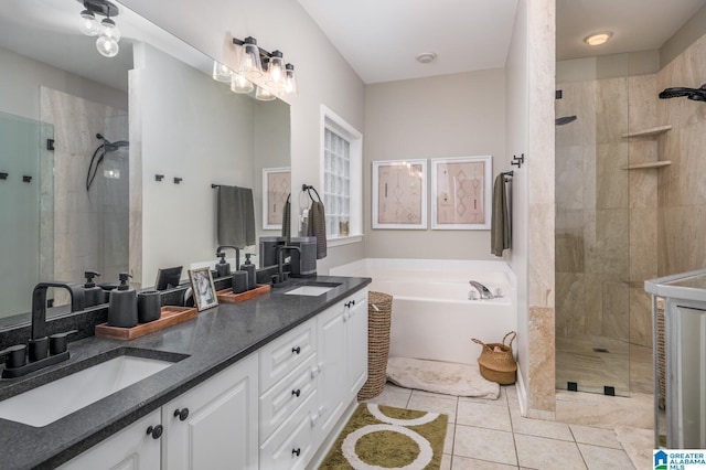 bathroom with tile patterned flooring, a tile shower, and a sink