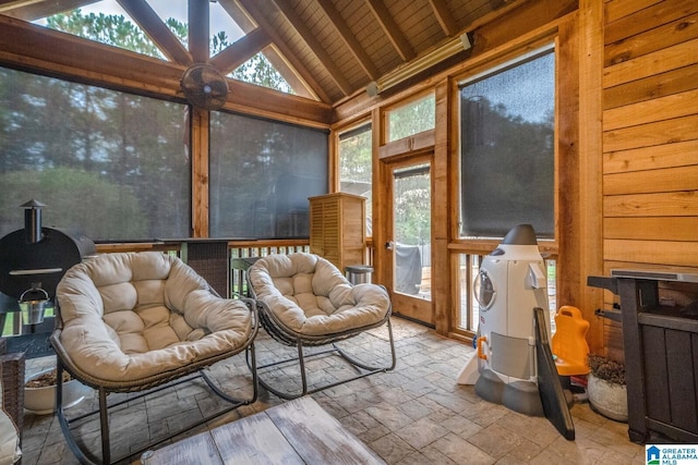 sunroom featuring a wealth of natural light, wood ceiling, and lofted ceiling with beams