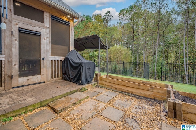 view of patio featuring area for grilling and fence