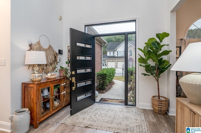 entrance foyer with wood finished floors and baseboards