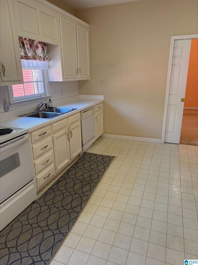 kitchen featuring baseboards, light countertops, light tile patterned flooring, white appliances, and a sink