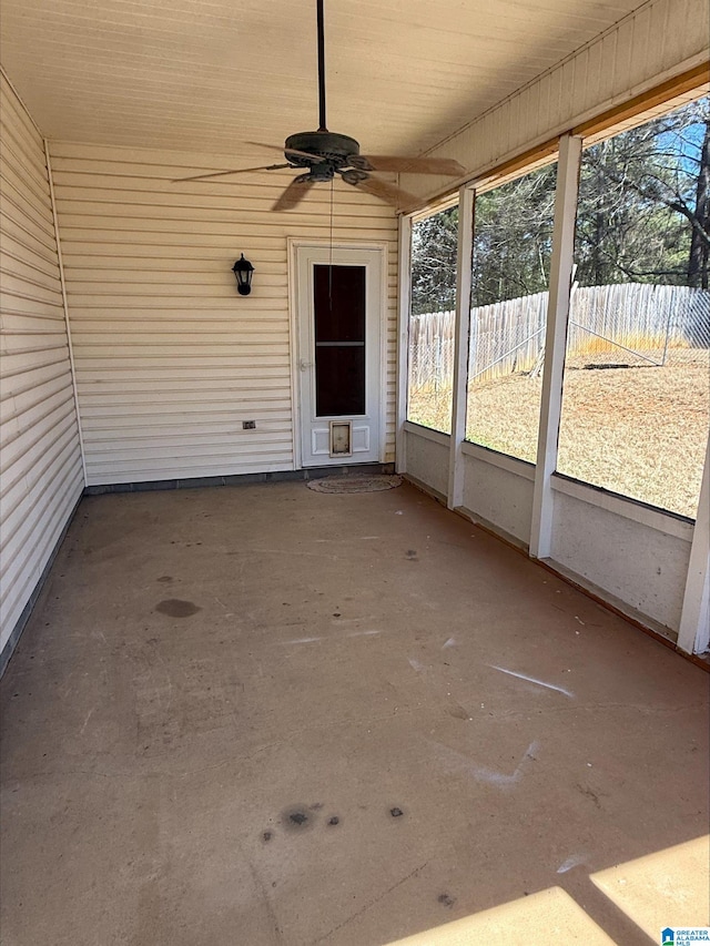 unfurnished sunroom with ceiling fan