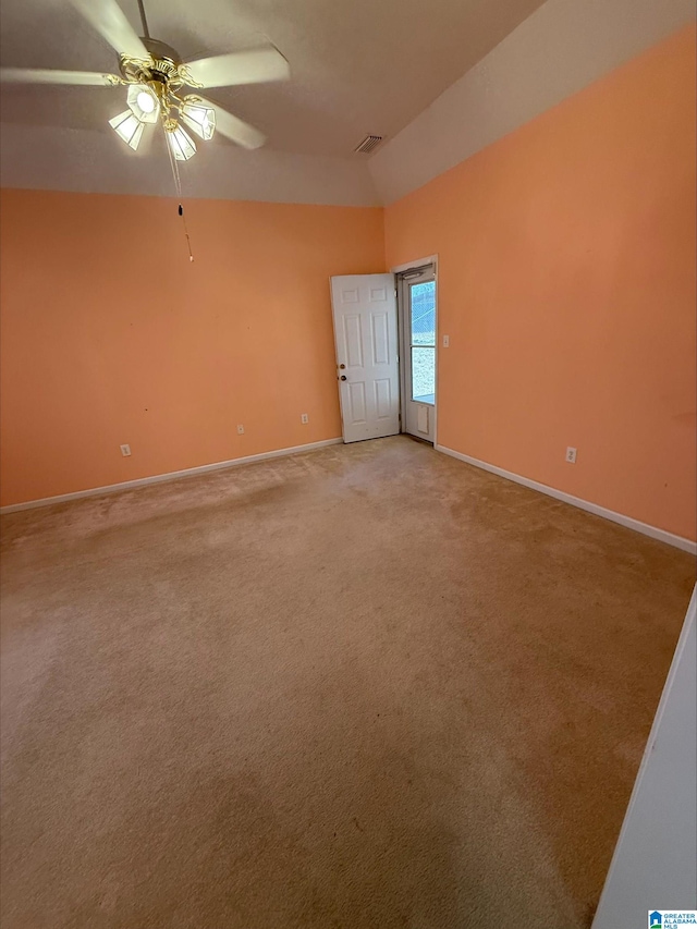 empty room featuring visible vents, light colored carpet, baseboards, and ceiling fan