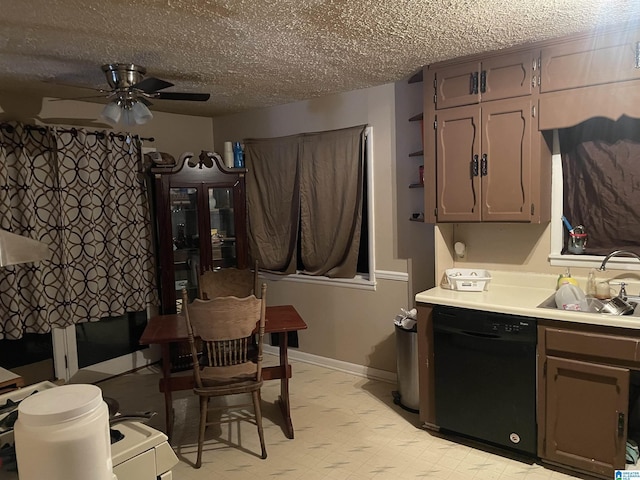 kitchen featuring light floors, ceiling fan, a sink, light countertops, and dishwasher