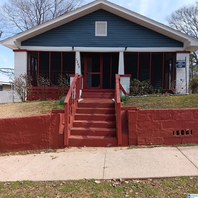 view of front of home featuring a sunroom