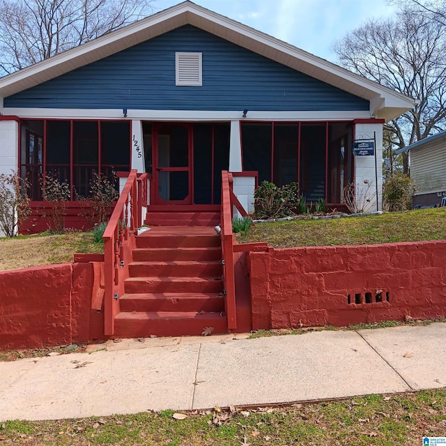 view of front of house featuring a porch and a sunroom