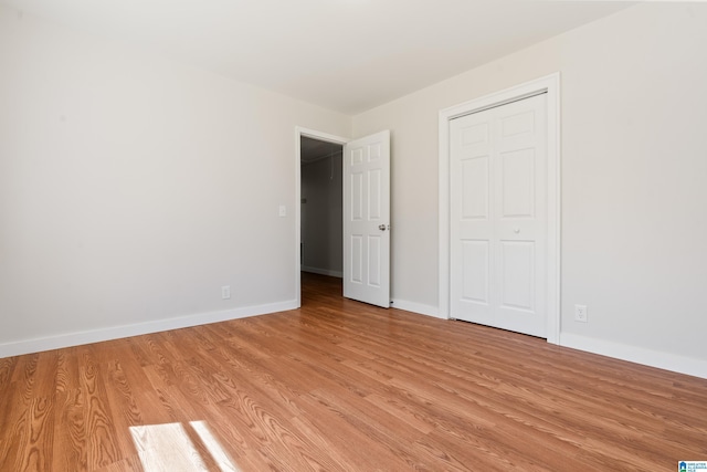 unfurnished bedroom with light wood-type flooring and baseboards