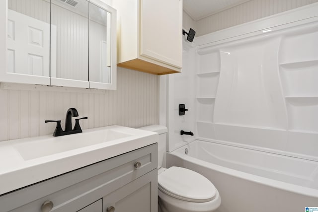 bathroom featuring tub / shower combination, toilet, and vanity