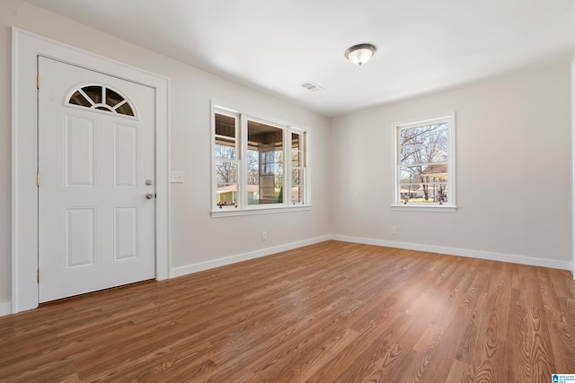 entrance foyer with visible vents, light wood-style flooring, and baseboards