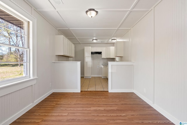 interior space with visible vents, baseboards, and light wood-style floors