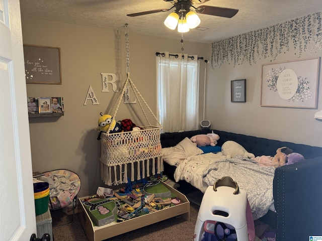 bedroom with carpet flooring, a textured ceiling, and a ceiling fan