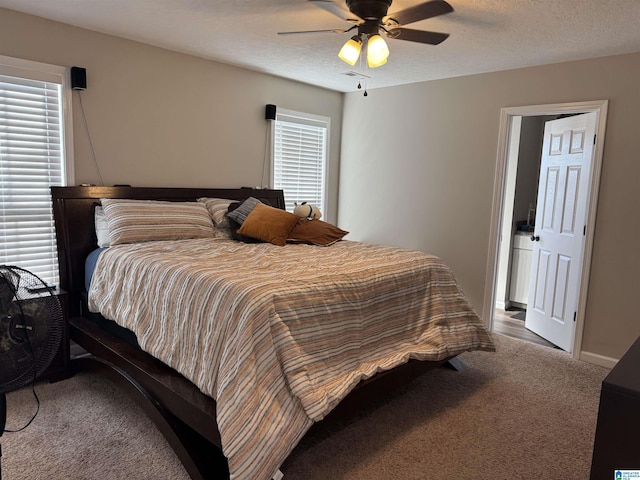 bedroom with baseboards, carpet flooring, a textured ceiling, and ceiling fan