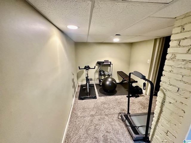 workout room with a drop ceiling, baseboards, and carpet floors