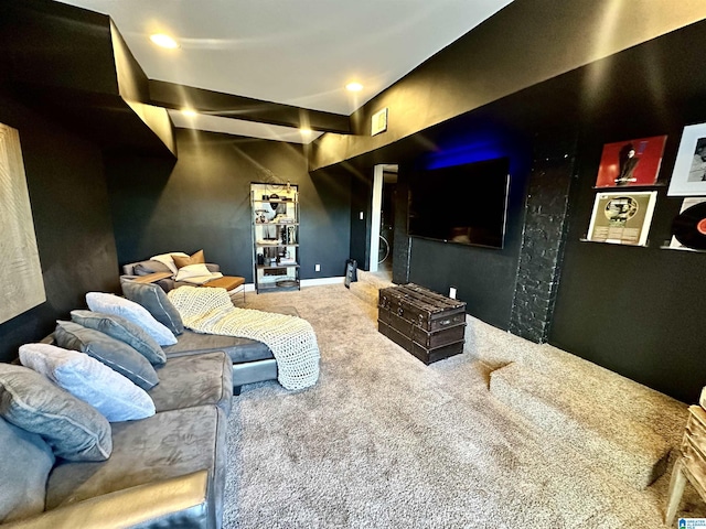 carpeted cinema room featuring visible vents and baseboards