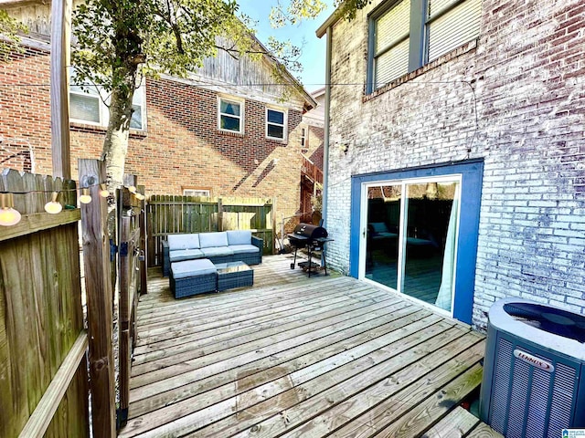 wooden terrace featuring cooling unit, an outdoor hangout area, grilling area, and fence